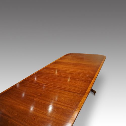 Regency style mahogany twin pillar dining table end view