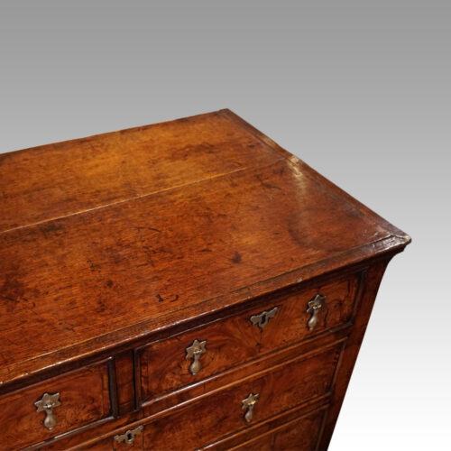 Queen Anne oak and burr elm chest of drawers top detail