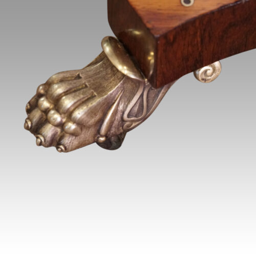Regency brass inlaid rosewood work table paw foot detail