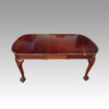 Edwardian mahogany claw and ball extending table with one leaf