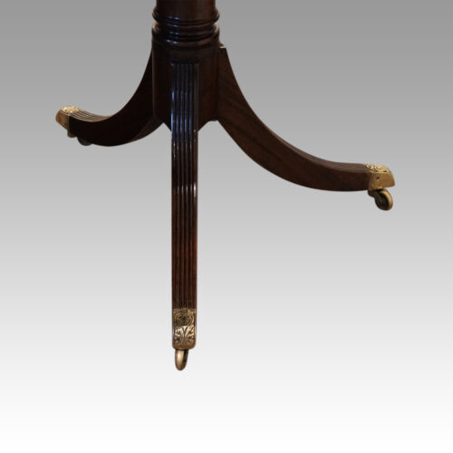 Regency style mahogany twin pillar table castors