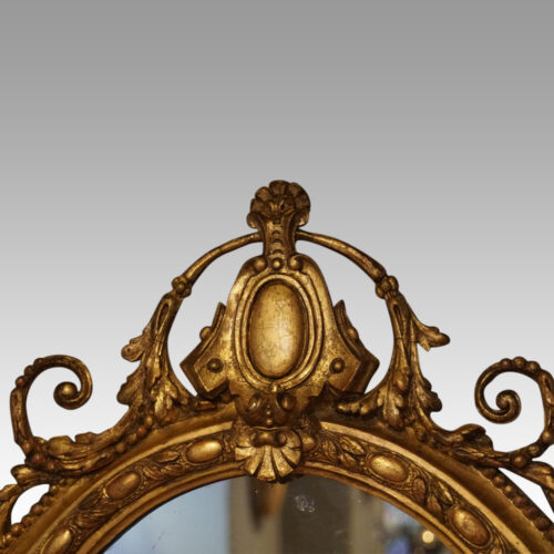 Antique gilt oval mirror crest detail