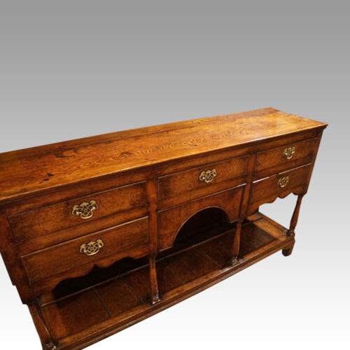 Antique oak dresser base at angle
