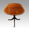 Regency style mahogany deep banded dining table end view