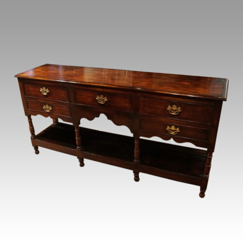 Antique potboard oak dresser base at angle