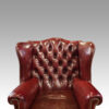 Pair of George VI leather wing chairs back details