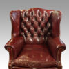 Pair of George VI leather wing chairs buttoned back