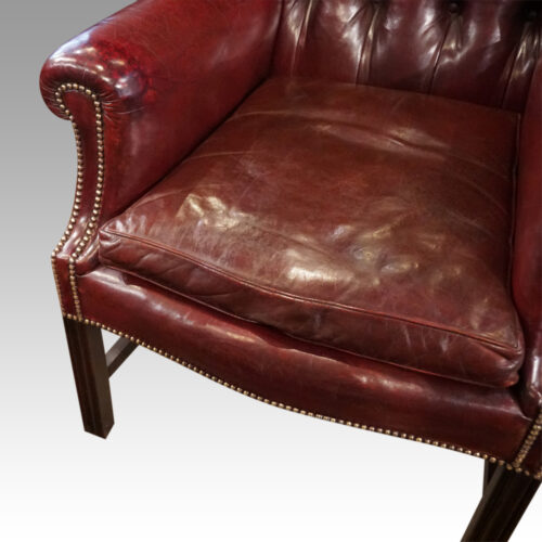 Pair of George VI leather wing chairs cushion
