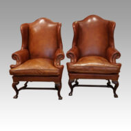 Pair of Georgian style leather wing chairs