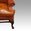 Pair of Georgian style leather wing chairs front leg detail