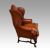 Pair of Georgian style leather wing chairs side