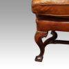 Pair of Georgian style leather wing chairs front leg detail