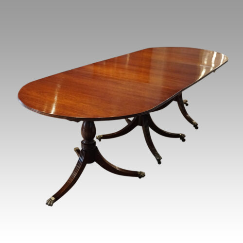 George III mahogany triple pillar dining table angle view