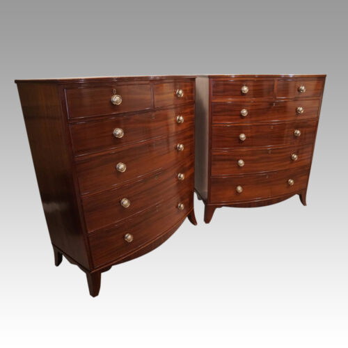 Pair of Georgian bow chests of drawers at angles
