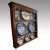 Antique oak plate rack at angle