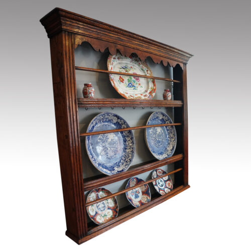 Antique oak plate rack at angle