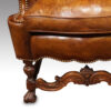 Antique walnut high back leather wingback chair front leg