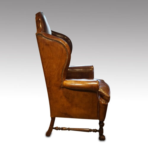Antique walnut high back leather wingback chair side view
