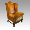 Pair of leather William and Mary wing chairs at angle