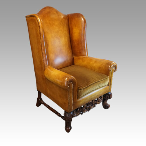 Pair of leather William and Mary wing chairs at angle