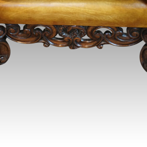 Pair of leather William and Mary wing chairs carving