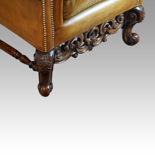 Pair of leather William and Mary wing chairs leg detail