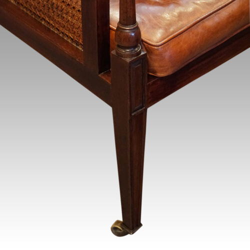 Antique mahogany bergere library chair front leg