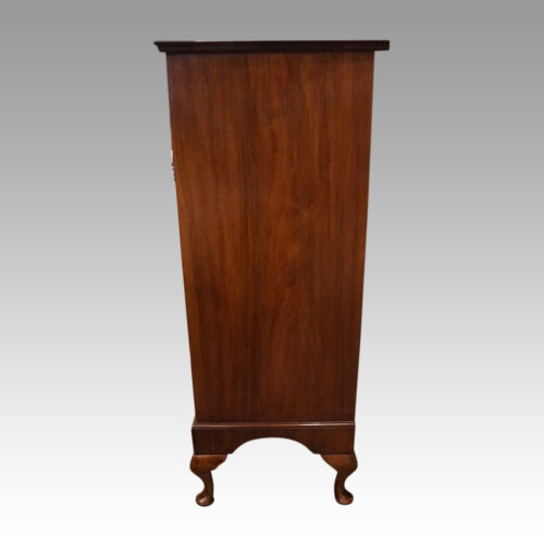 Tall walnut chest side view