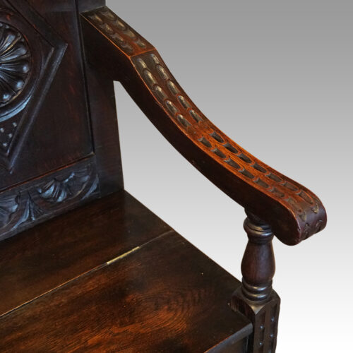 Victorian carved oak settle arm