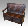 Victorian carved oak settle at angle