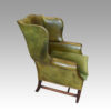 Edwardian green leather wing chair angle