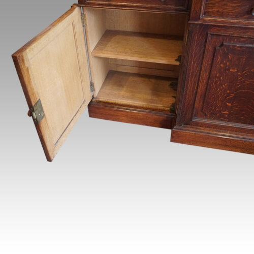 Edwardian oak breakfront bookcase interior end base