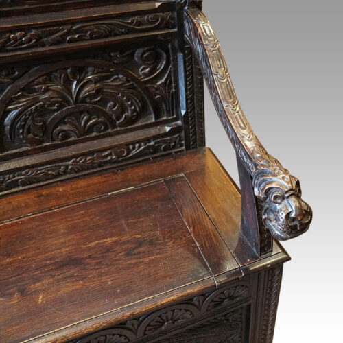 Victorian carved oak settle arm
