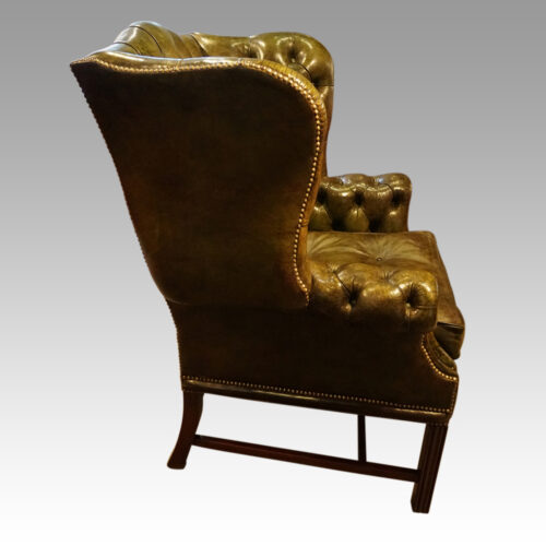 Georgian style leather button back wing chair side view