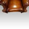 Pair of Edwardian leather wing chairs concave seat
