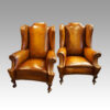 Pair of Edwardian leather wing chairs front
