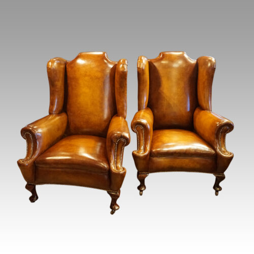 Pair of Edwardian leather wing chairs front
