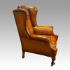 Pair of Edwardian leather wing chairs side