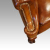 Pair of Edwardian leather wing chairs studding