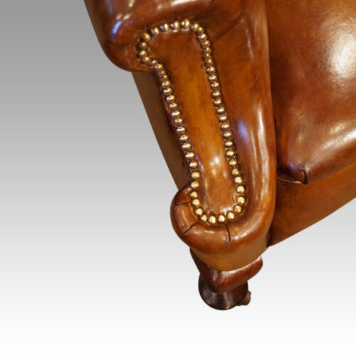 Pair of Edwardian leather wing chairs studding