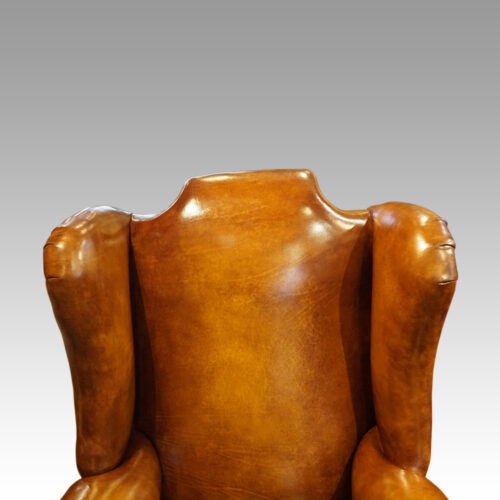 Pair of Edwardian leather wing chairs wings