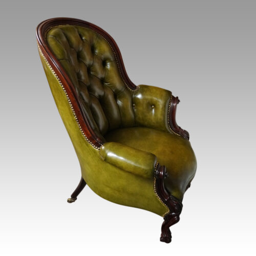 Victorian button back leather easy chair at side