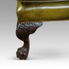 Antique Irish green leather wingchairs carving