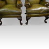 Antique Irish green leather wingchairs front