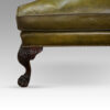 Antique Irish green leather wingchairs front leg