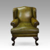 Antique Irish green leather wingchairs front view