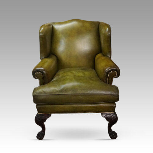 Antique Irish green leather wingchairs front view