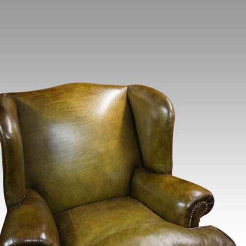 Antique Irish green leather wingchairs inside wing view