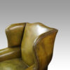 Antique Irish green leather wingchairs outer wing view