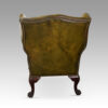 Antique Irish green leather wingchairs rear